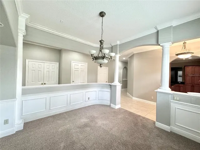 a large white kitchen with granite countertop a sink and dishwasher with white cabinets