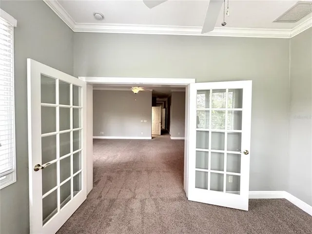 an empty room with windows and closet