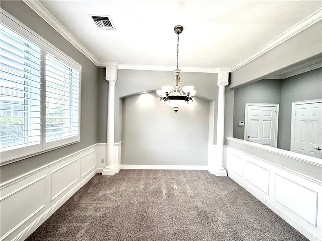 a view of a room with a window and chandelier