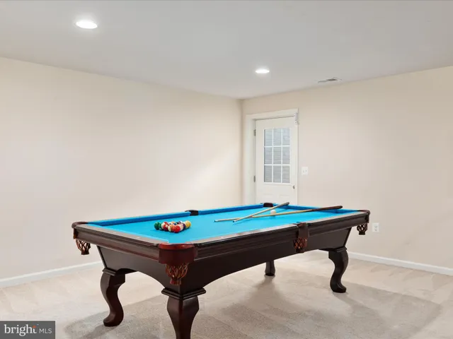 an aerial view of residential houses with outdoor space and swimming pool