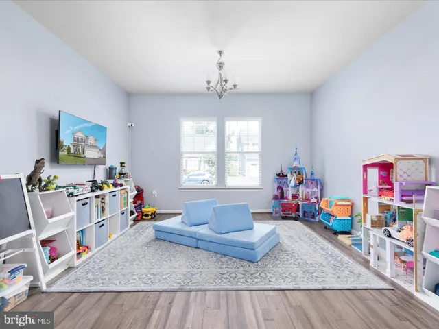 a kitchen with white cabinets and a refrigerator