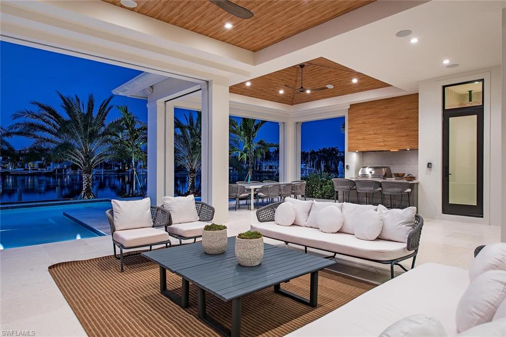 2999 Rum Row Naples, FL 34102 - Photo 20 of 33 View of patio featuring an outdoor hangout area, an outdoor kitchen, outdoor dining area, and ceiling fan