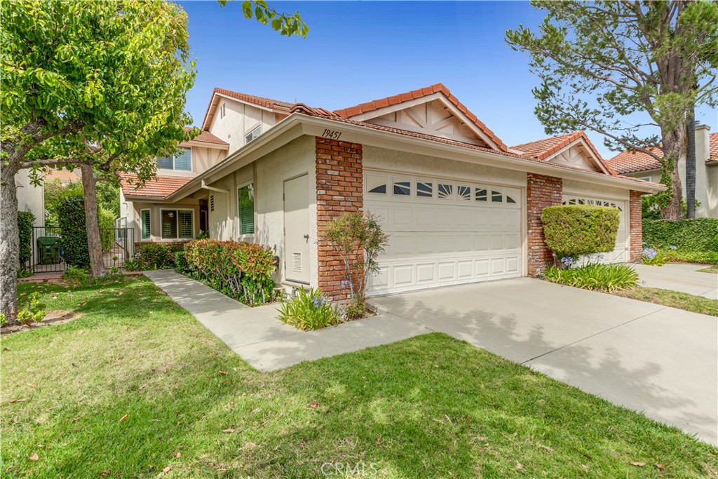 19451 Eagle Ridge Lane Porter Ranch, CA 91326 - Photo 8 of 59 a front view of a house with a yard and garage