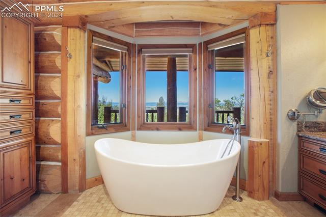616 Summit Road Hartsel, CO 80449 - Photo 28 of 50 Bathroom featuring vanity, tile patterned flooring, and a bathtub