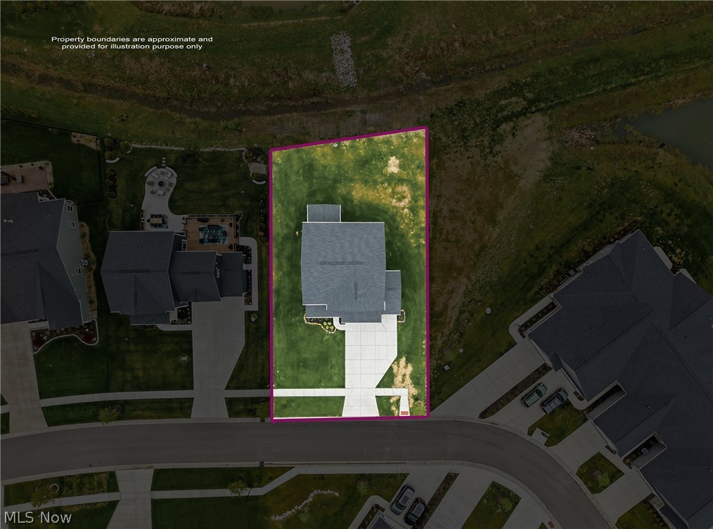 5358 Walnut Rdg Lane Sheffield Lake, OH 44054 - Photo 45 of 50 Aerial view showcasing a residential property with a defined boundary, a gray-roofed structure, and a concrete driveway