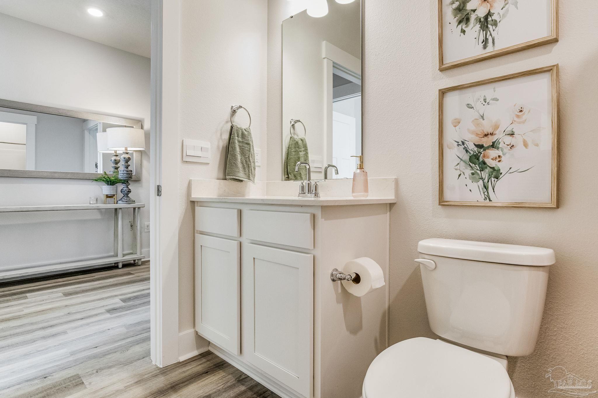 3238 Grouse Road Pace, FL 32571 - Photo 28 of 50 a bathroom with a toilet a sink and mirror