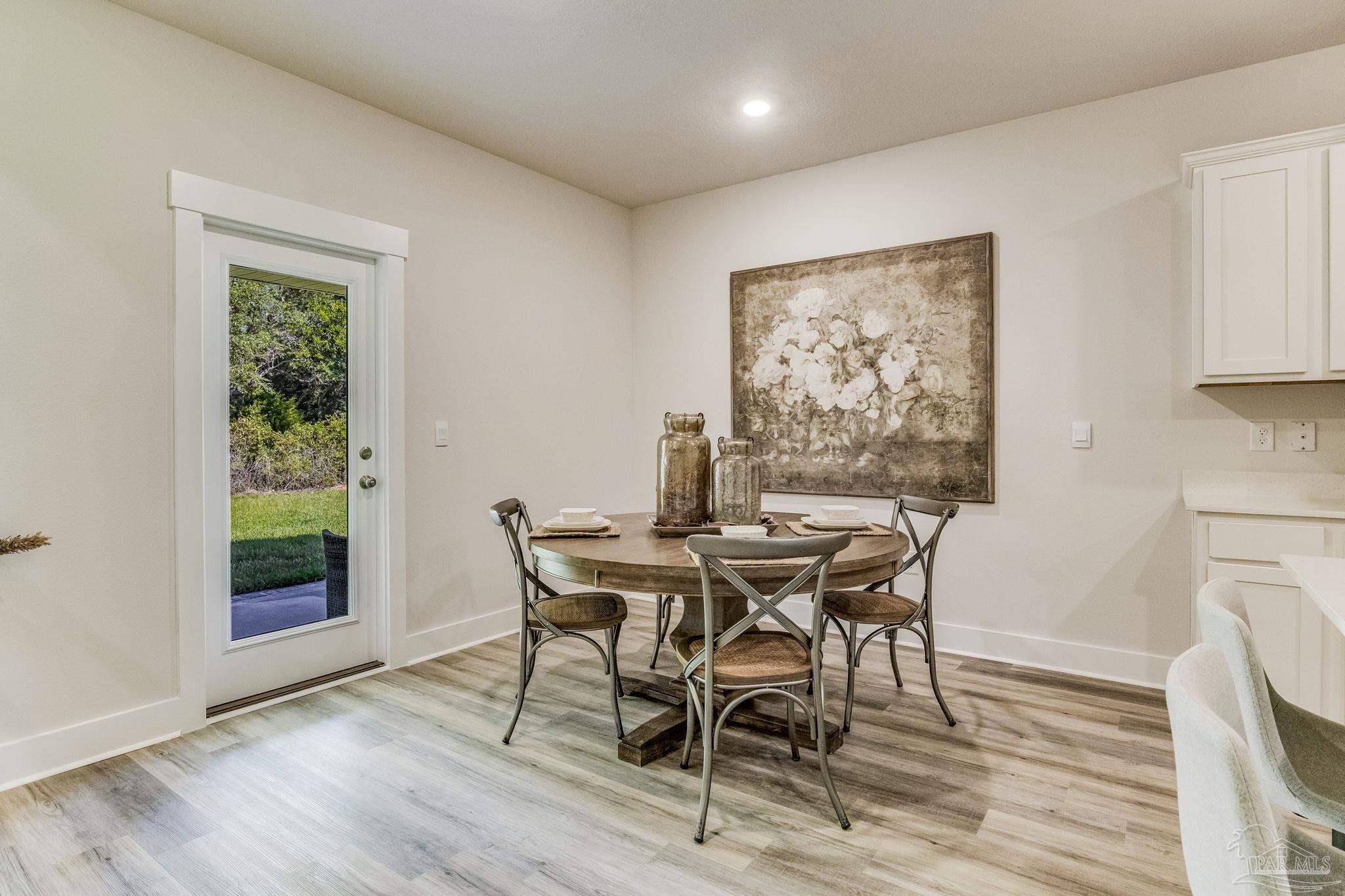 3238 Grouse Road Pace, FL 32571 - Photo 8 of 50 a view of a dining room with furniture and wooden floor