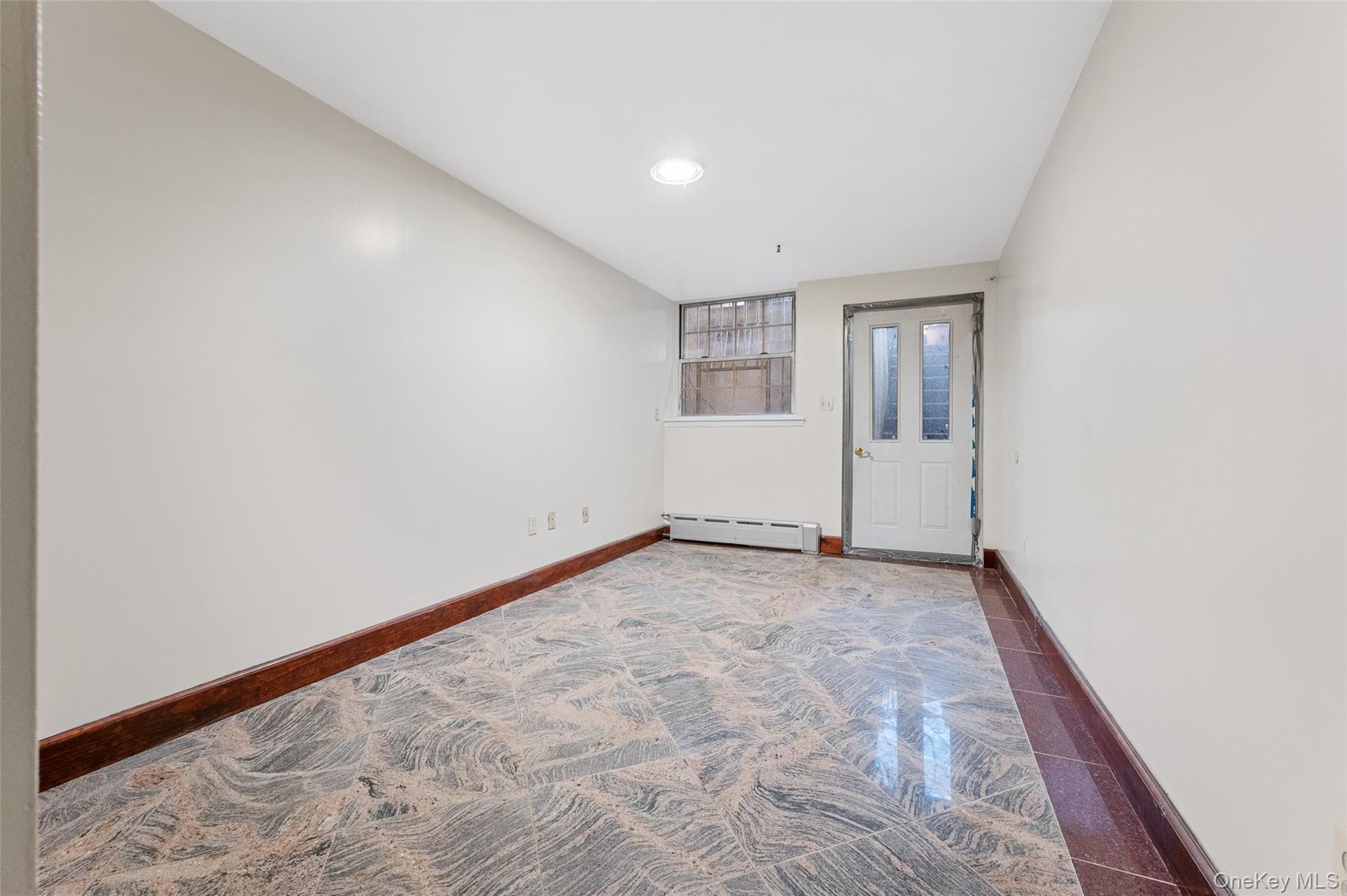 108-10 35th Avenue Queens, NY 11368 - Photo 14 of 29 Spare room featuring granite floors, a baseboard radiator, and recessed lighting