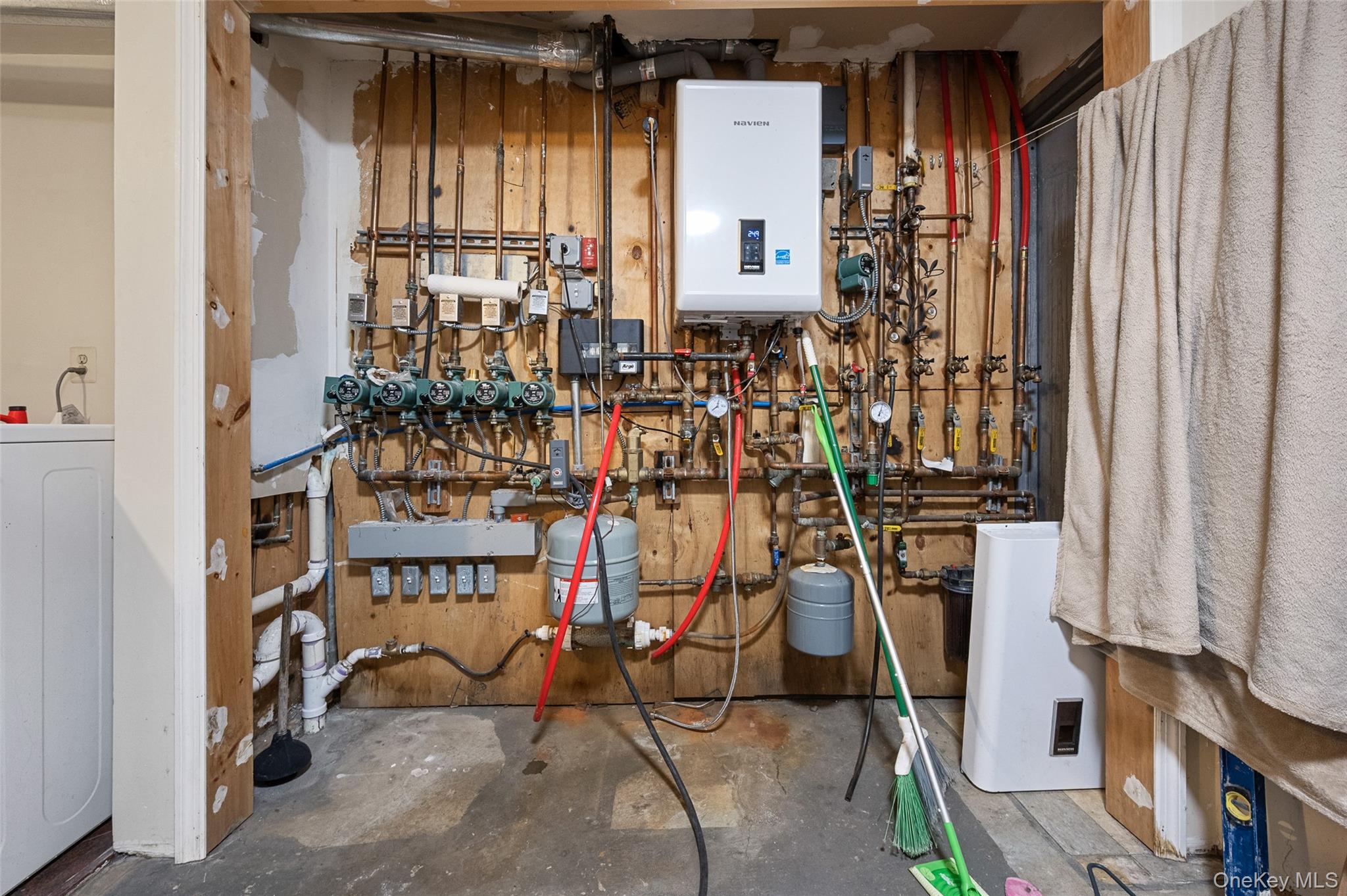 108-10 35th Avenue Queens, NY 11368 - Photo 19 of 29 Utility room with washer / clothes dryer and water heater