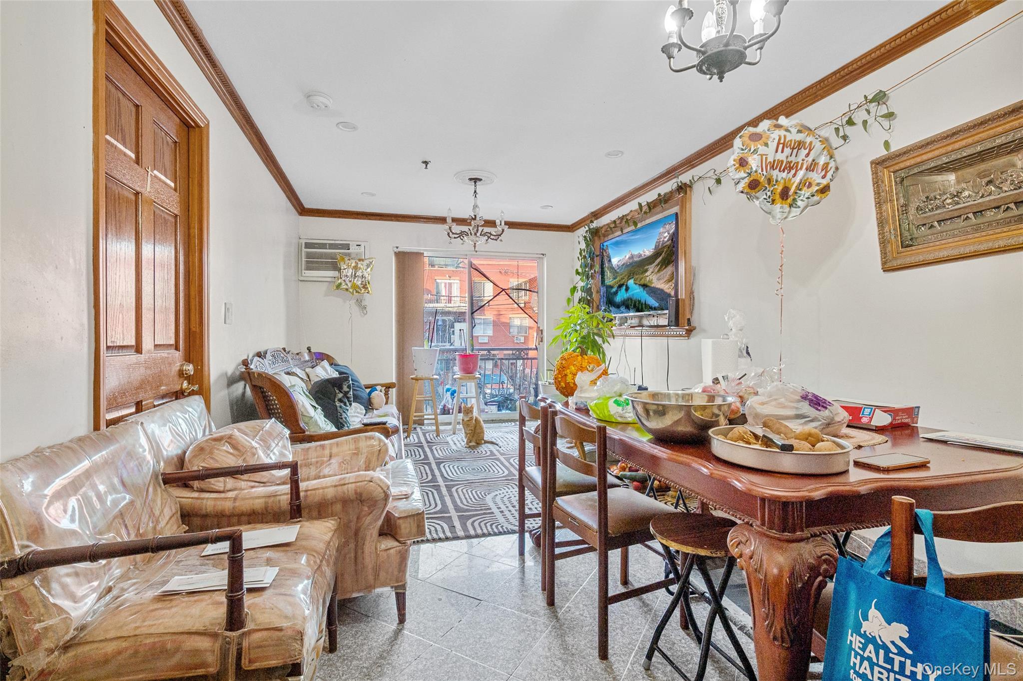 108-10 35th Avenue Queens, NY 11368 - Photo 23 of 29 Dining space with a chandelier, crown molding, granite tiled floors, and a wall unit AC