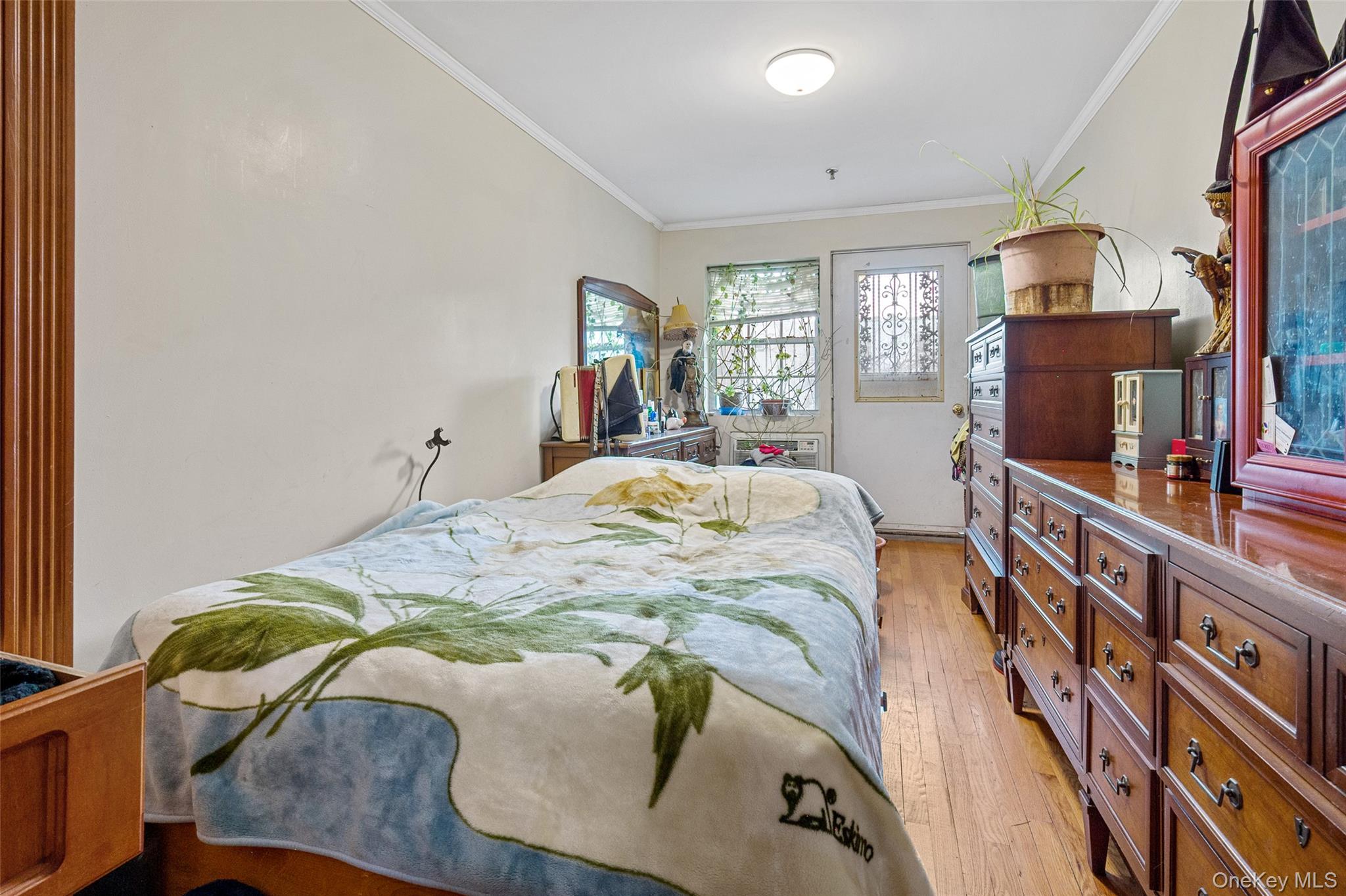 108-10 35th Avenue Queens, NY 11368 - Photo 25 of 29 Bedroom featuring light wood-type flooring and ornamental molding