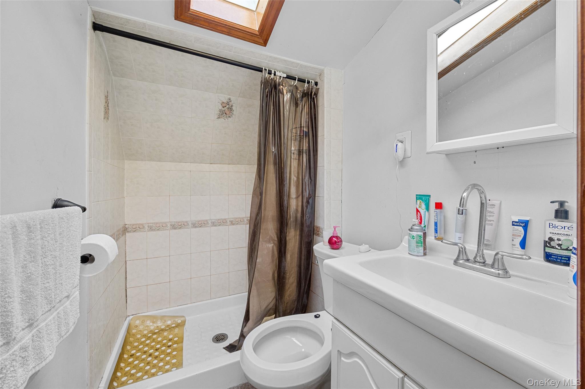 108-10 35th Avenue Queens, NY 11368 - Photo 28 of 29 Full bathroom with a skylight, a stall shower, and vanity