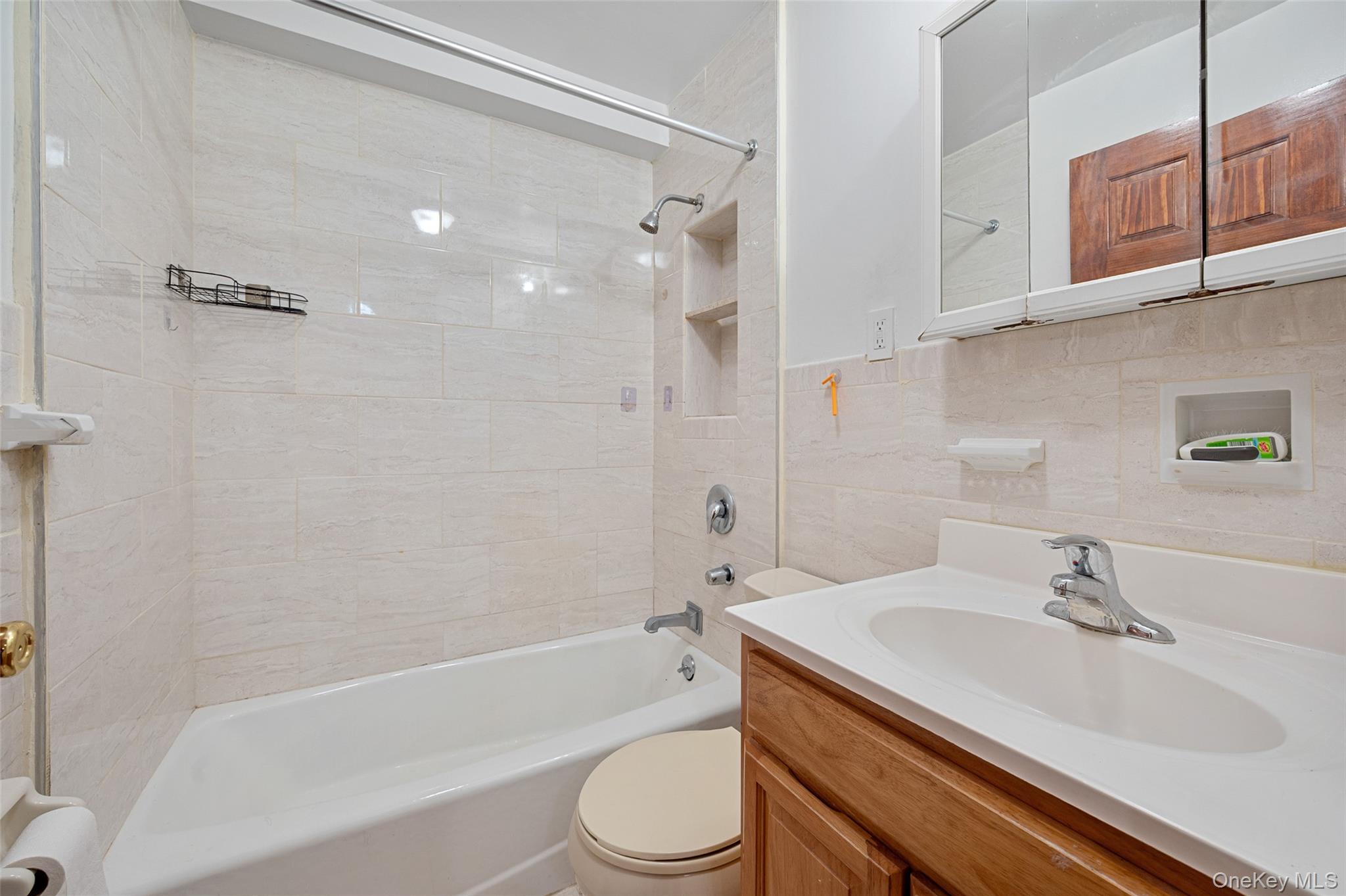 108-10 35th Avenue Queens, NY 11368 - Photo 7 of 29 Full bath featuring vanity, shower / washtub combination, and tile walls