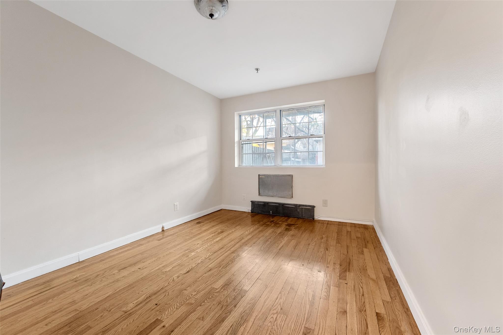 108-10 35th Avenue Queens, NY 11368 - Photo 9 of 29 Empty room featuring light wood-style flooring and baseboards