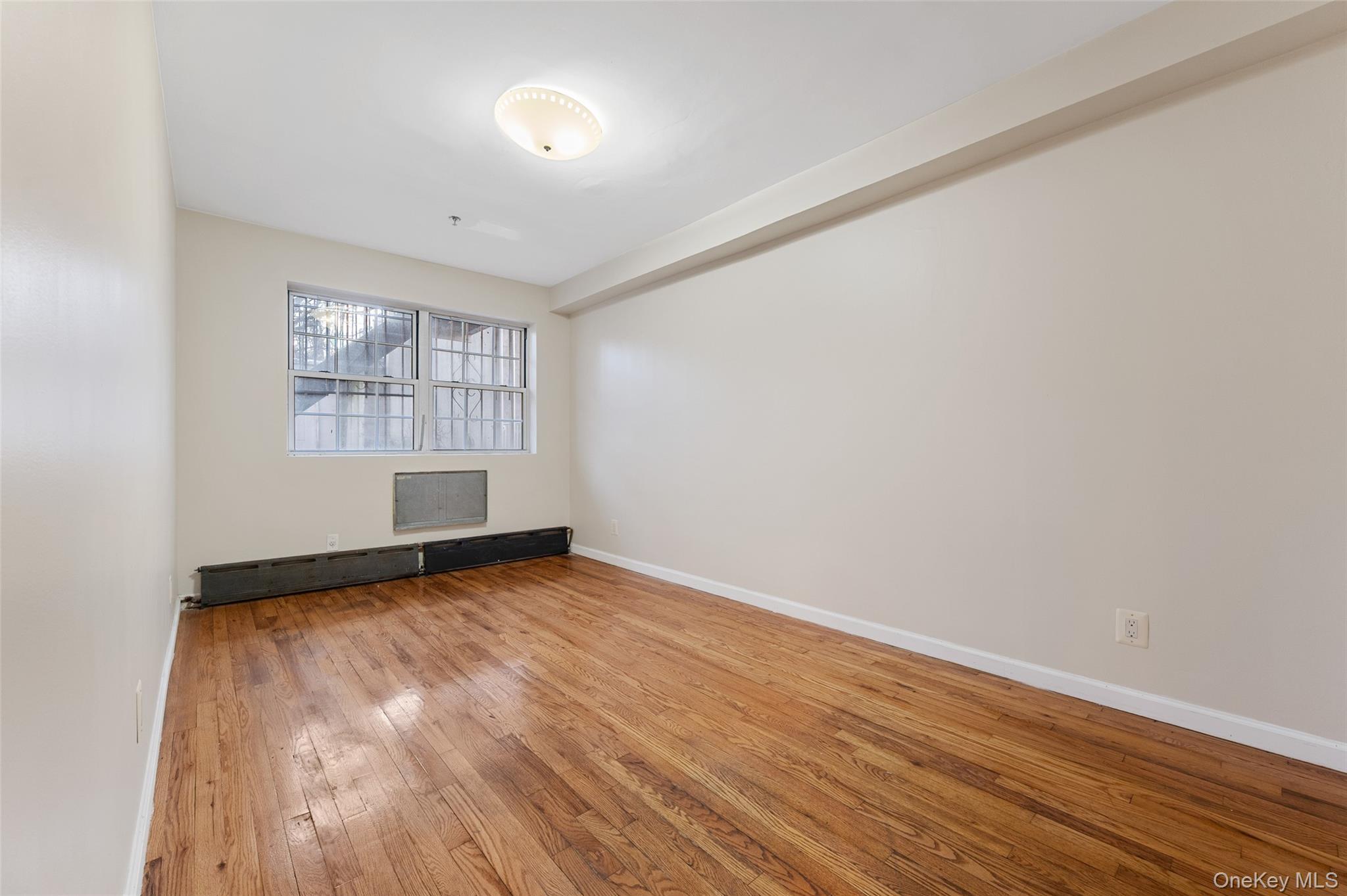 108-10 35th Avenue Queens, NY 11368 - Photo 10 of 29 Unfurnished room with light wood-type flooring and baseboards
