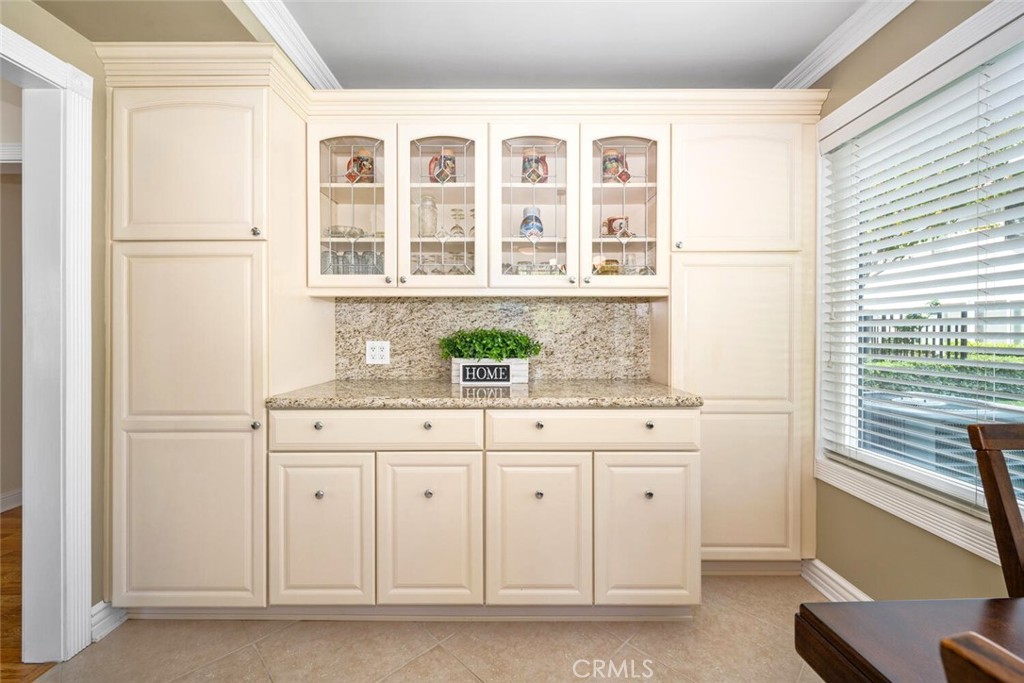 11253 Gardiners Court Cypress, CA 90630 - Photo 33 of 74 a bathroom with a granite countertop sink and a window