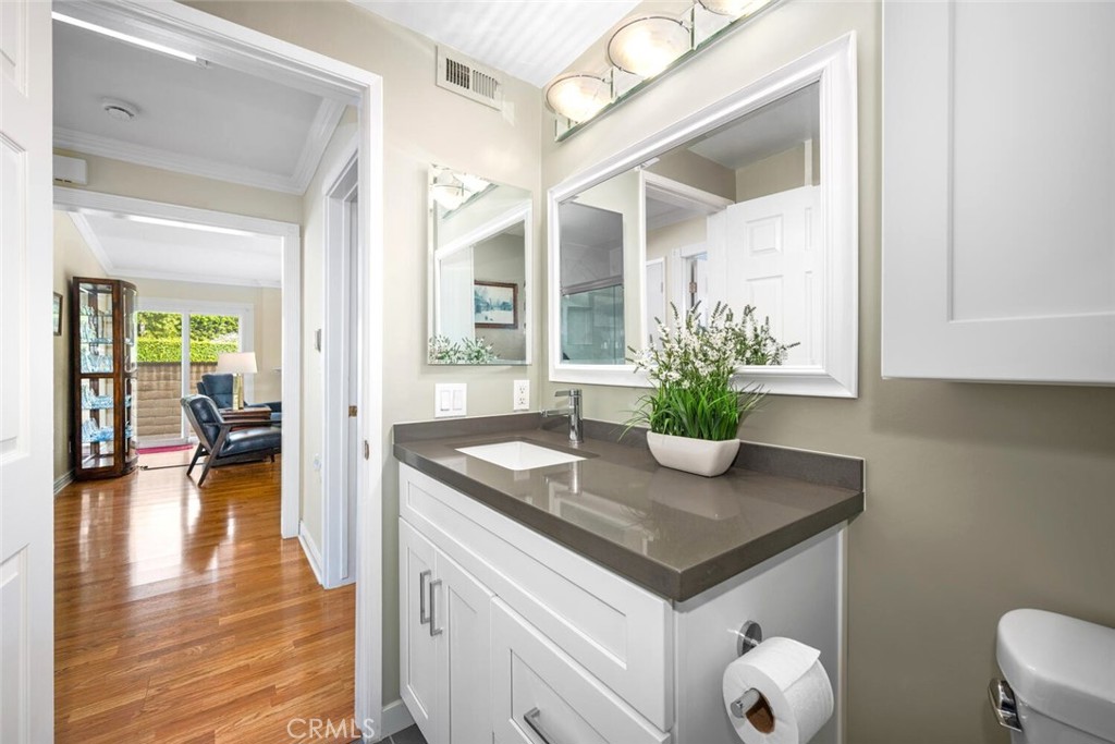11253 Gardiners Court Cypress, CA 90630 - Photo 54 of 74 a view of living room and kitchen with wooden floor