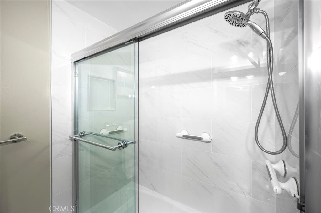 11253 Gardiners Court Cypress, CA 90630 - Photo 56 of 74 a bathroom with a glass shower door