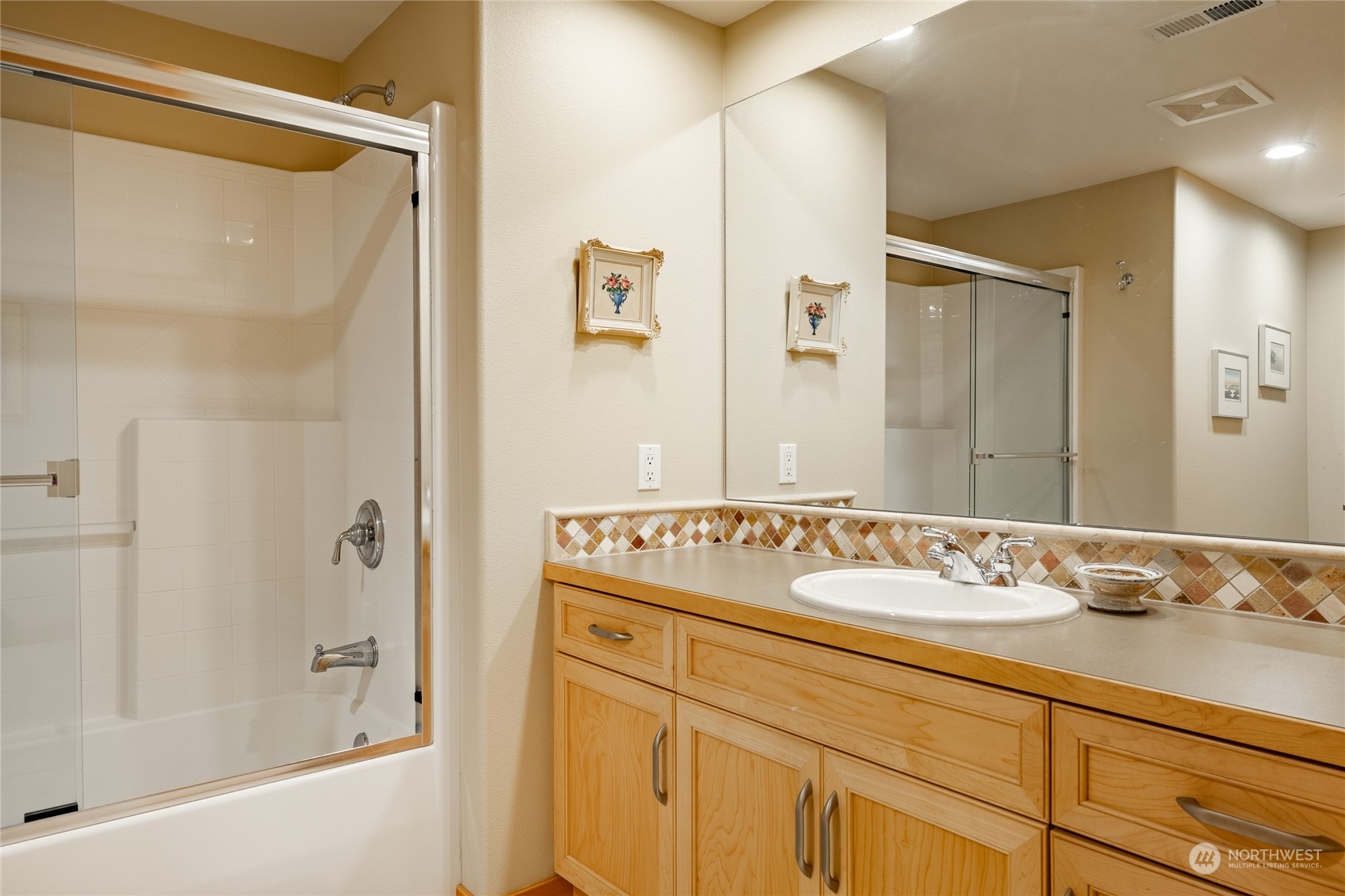 8148 Comox Road Blaine, WA 98230 - Photo 23 of 40 a bathroom with a sink and a mirror