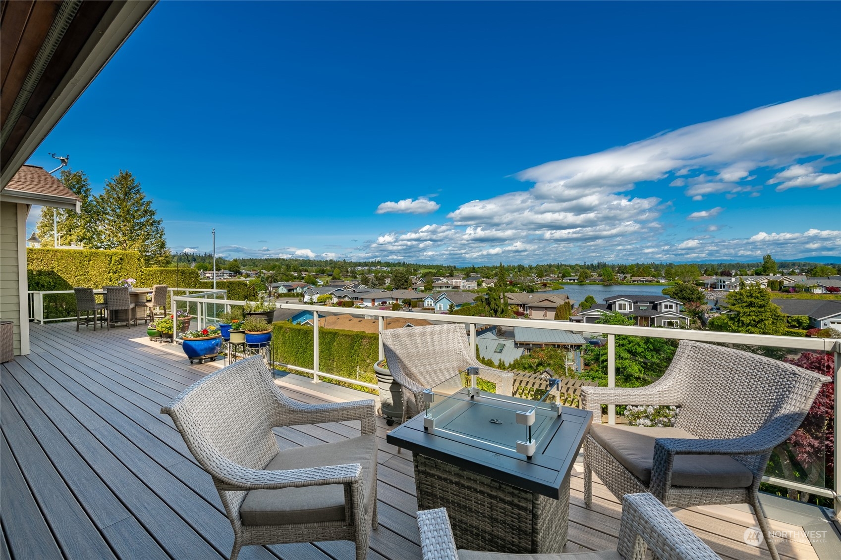 8148 Comox Road Blaine, WA 98230 - Photo 9 of 40 a view of a balcony with dining table and chairs with wooden floor