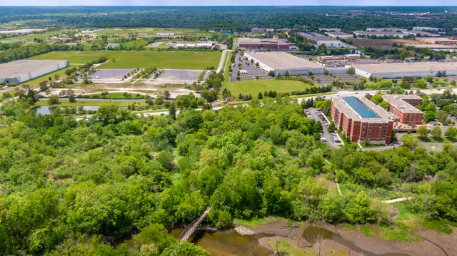 an aerial view of residential houses with outdoor space and swimming pool