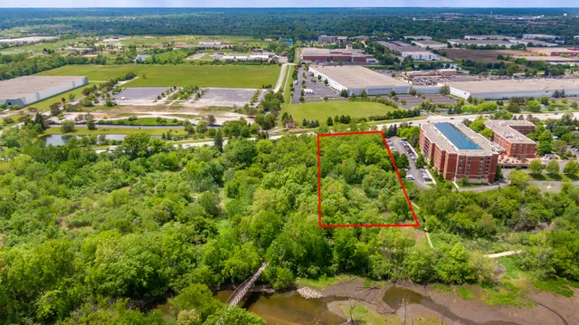 an aerial view of residential houses with outdoor space and river