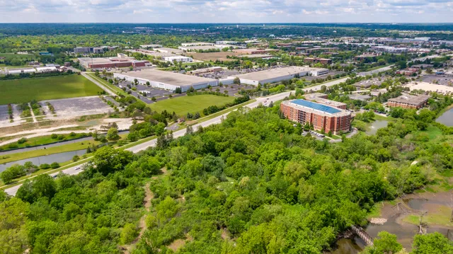 an aerial view of residential houses with outdoor space and swimming pool