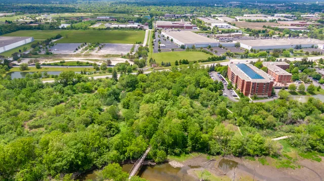 an aerial view of residential houses with outdoor space and street view