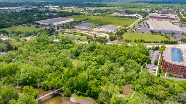 an aerial view of residential houses with outdoor space and river