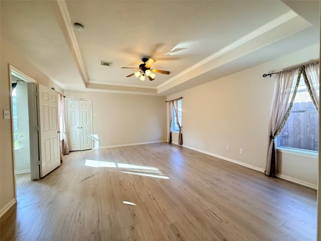 wooden floor in an empty room with a window