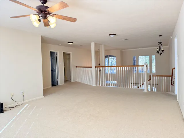 a view of a livingroom with a ceiling fan and window