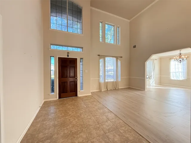 an empty room with windows and cabinet