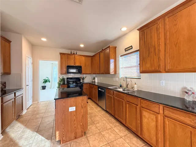 a large kitchen with granite countertop lots of counter top space