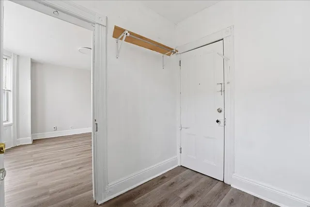 a view of closet area with wooden floor