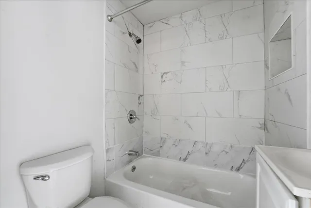 a bathroom with a bathtub and toilet