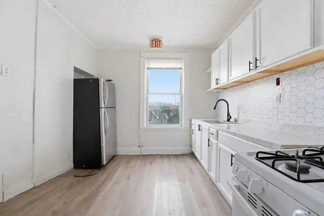 a kitchen with a refrigerator and a sink