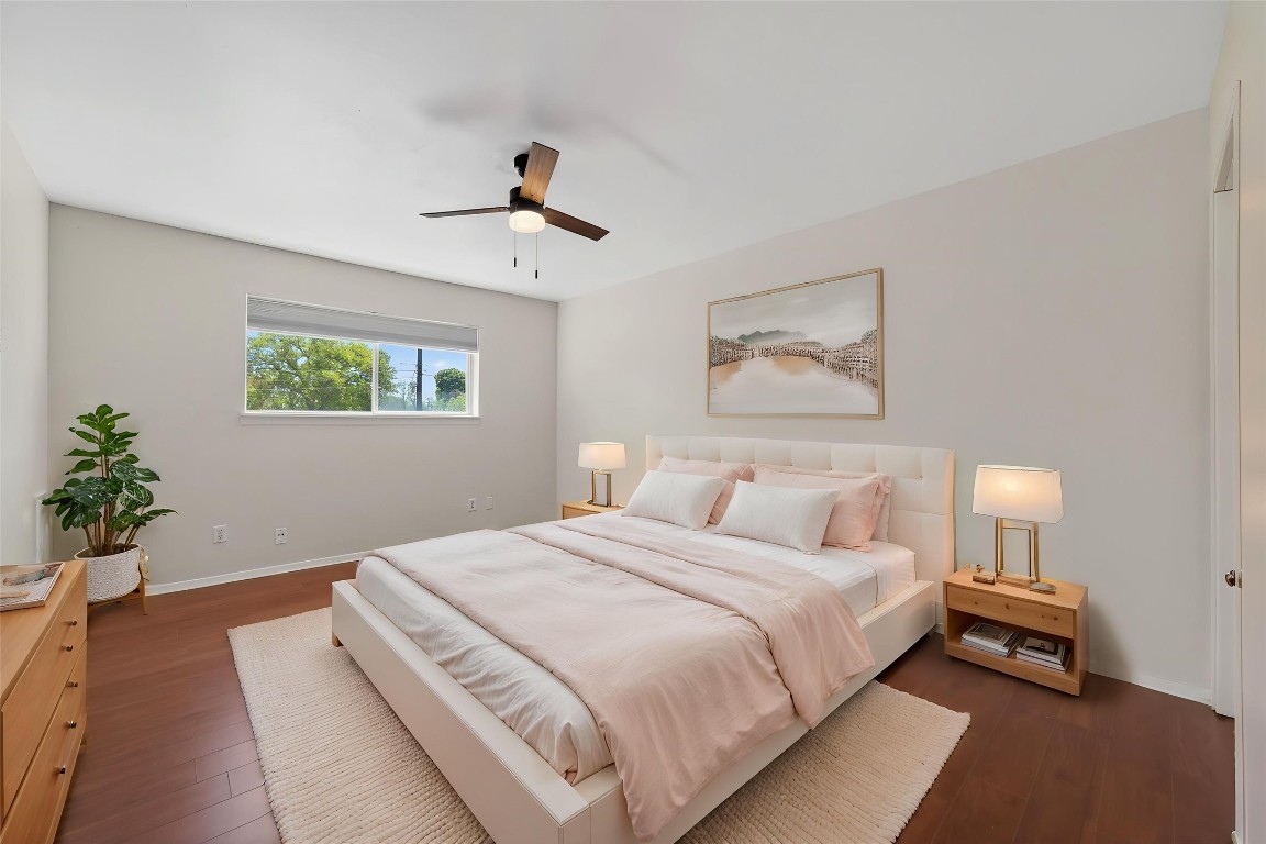 7205 Beechnut Street, Unit D Houston, TX 77074 - Photo 11 of 20 a bedroom with a large bed and a potted plant