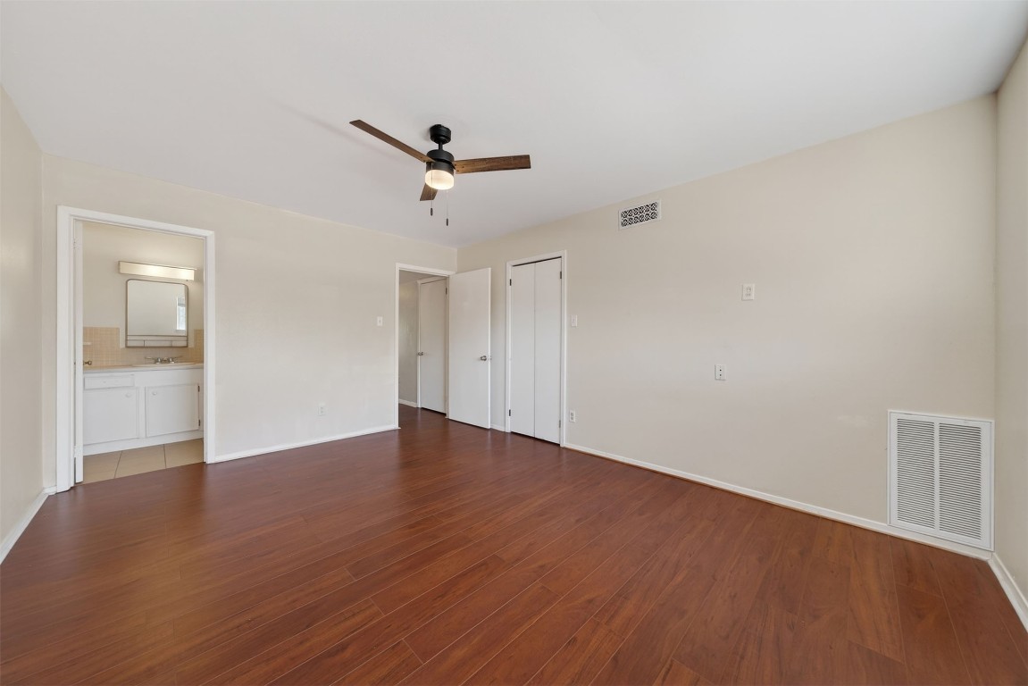 7205 Beechnut Street, Unit D Houston, TX 77074 - Photo 12 of 20 a view of empty room with wooden floor and ceiling fan