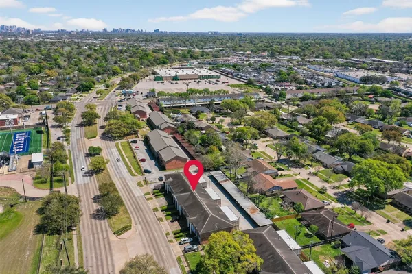 an aerial view of residential houses with outdoor space
