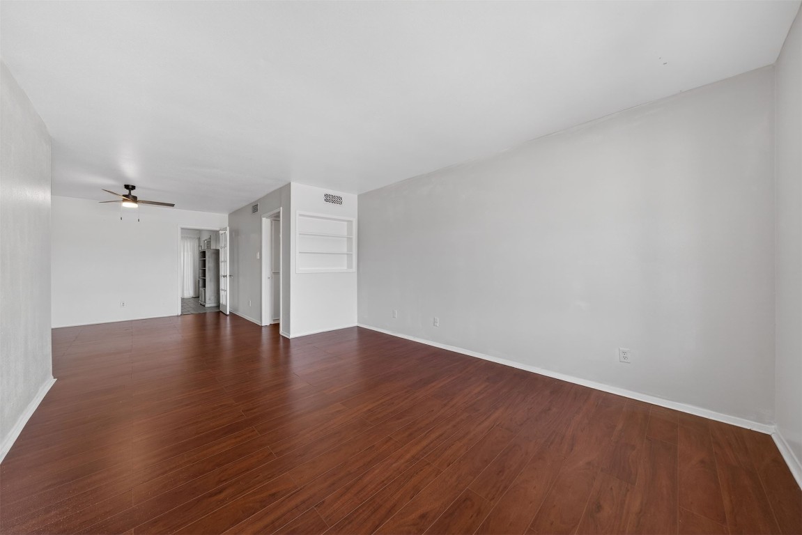7205 Beechnut Street, Unit D Houston, TX 77074 - Photo 2 of 20 a view of an empty room with wooden floor and a ceiling fan
