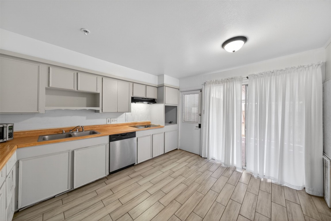 7205 Beechnut Street, Unit D Houston, TX 77074 - Photo 6 of 20 a large kitchen with stainless steel appliances granite countertop a lot of counter space and wooden floors