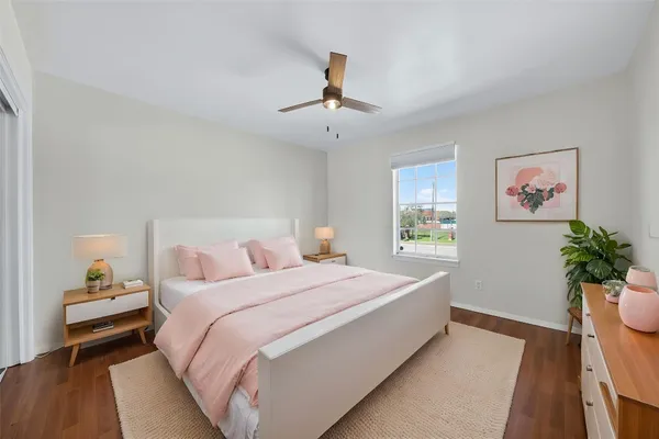 a bedroom with a large bed and a chandelier