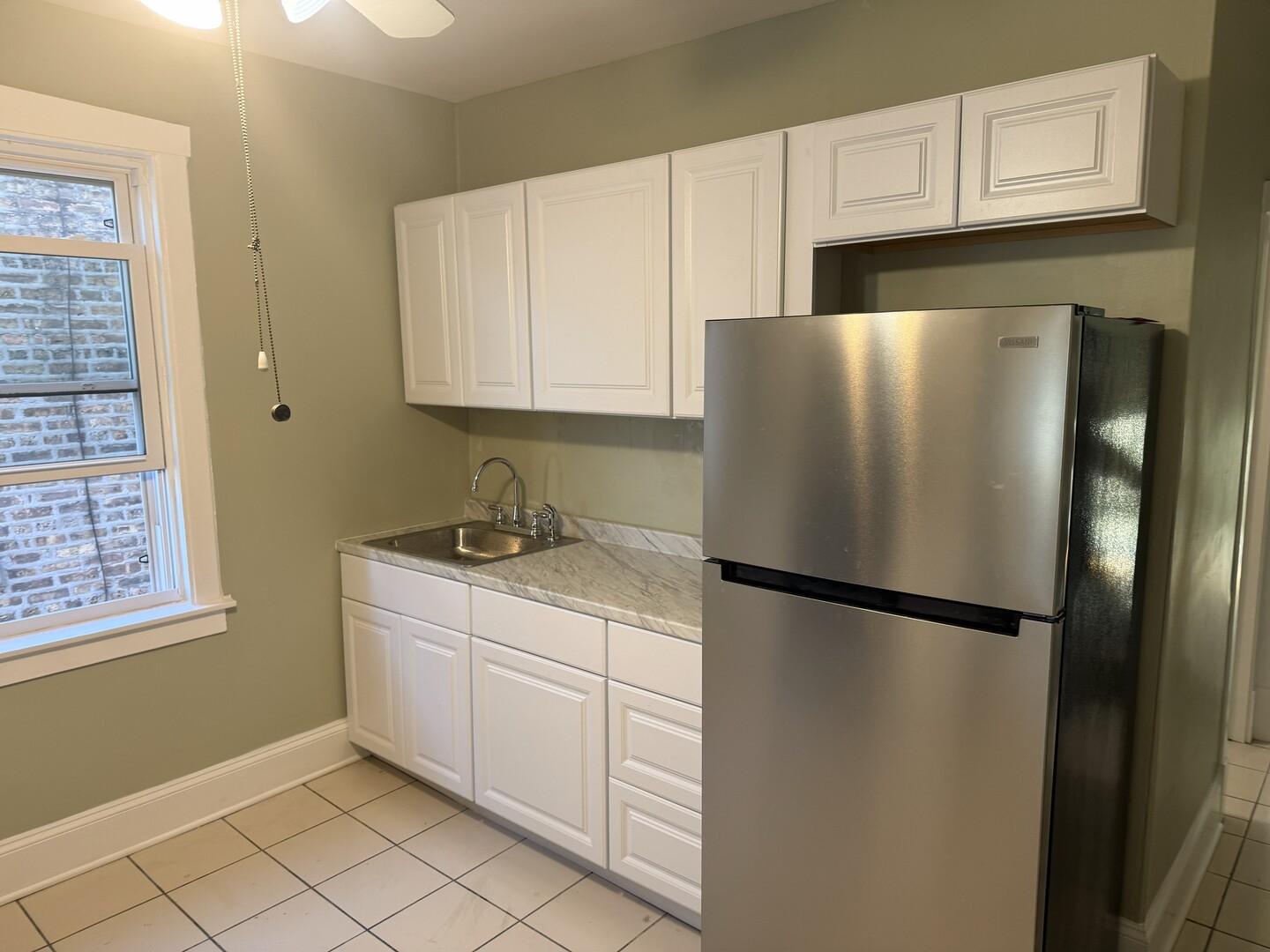 4253 North Austin Avenue, Unit 2 Chicago, IL 60634 - Photo 2 of 9 a white refrigerator freezer sitting inside of a kitchen