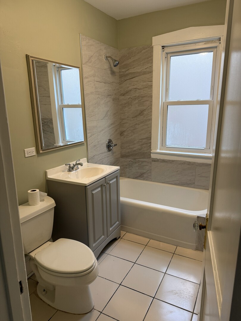 4253 North Austin Avenue, Unit 2 Chicago, IL 60634 - Photo 9 of 9 a bathroom with a sink toilet and shower