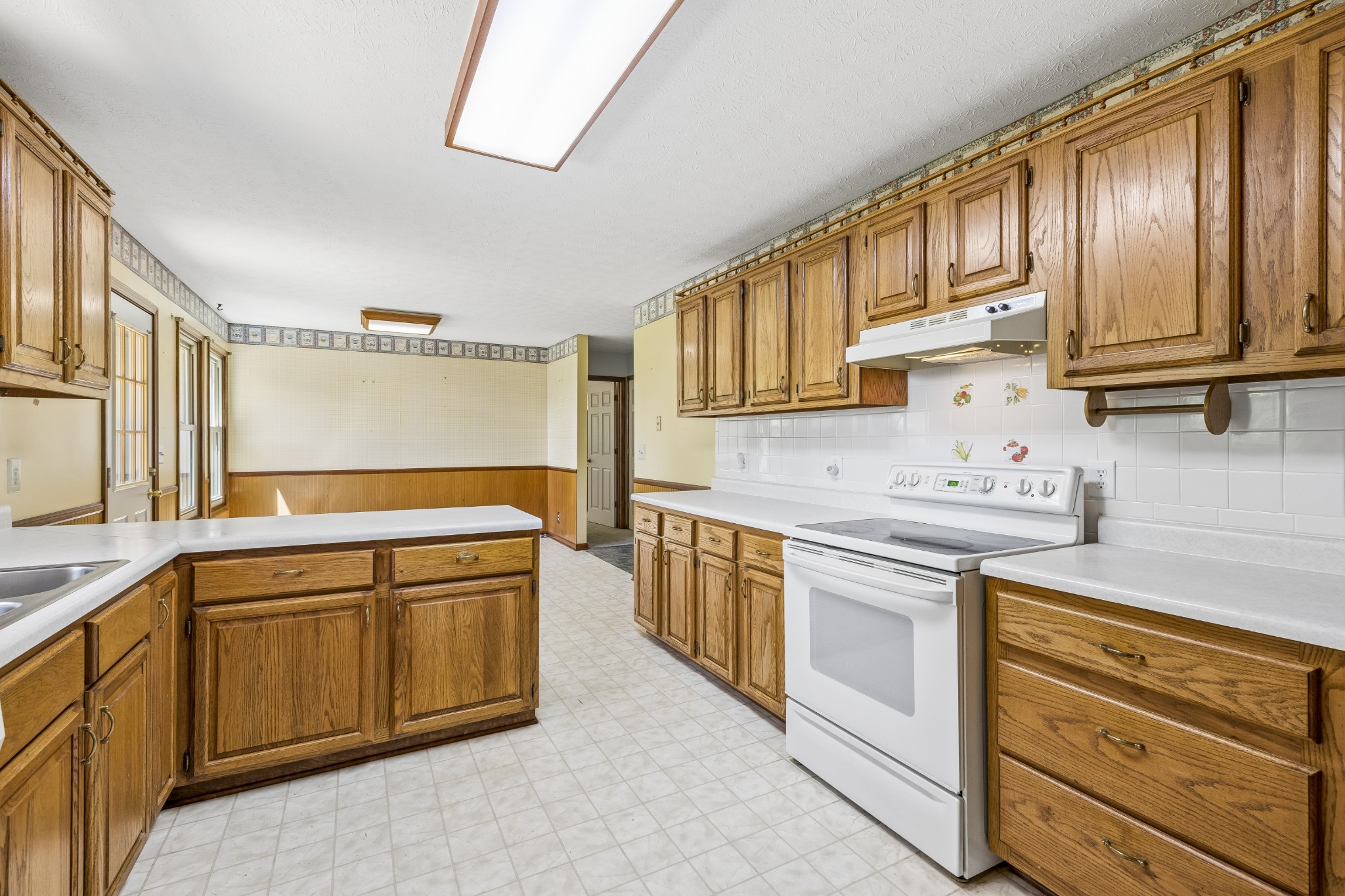 1690 Lawrence Lane Springfield, TN 37172 - Photo 11 of 64 a kitchen with stainless steel appliances granite countertop a sink stove and cabinets