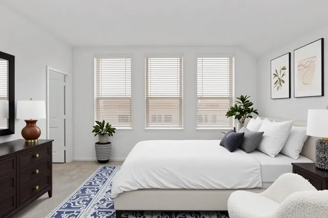 a bedroom with a large bed and a window