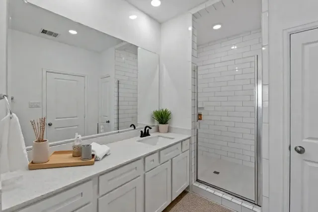 a bathroom with a double vanity sink and a mirror