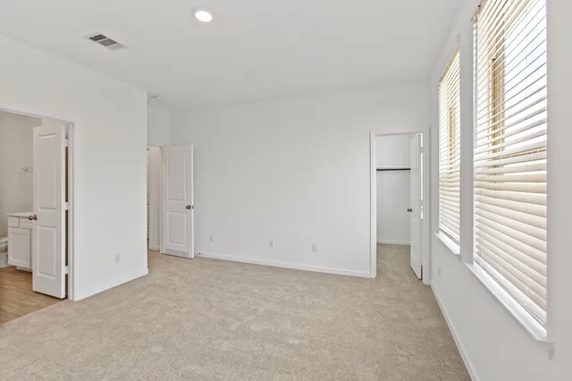a view of an empty room and a window