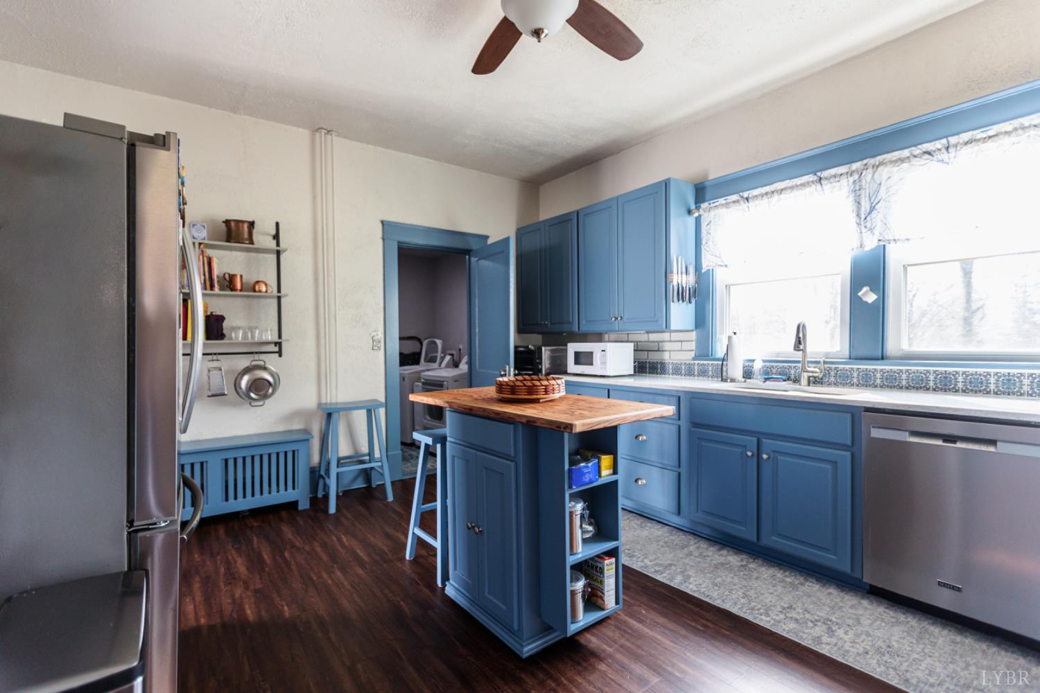 172 Pecan Street Pamplin, VA 23958 - Photo 12 of 40 a kitchen with wooden floors and wooden cabinets