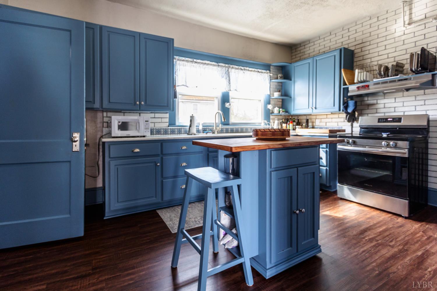 172 Pecan Street Pamplin, VA 23958 - Photo 14 of 40 a kitchen with wooden floors and wooden cabinets